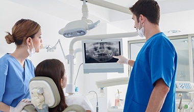 dentist showing a patient their X-rays 