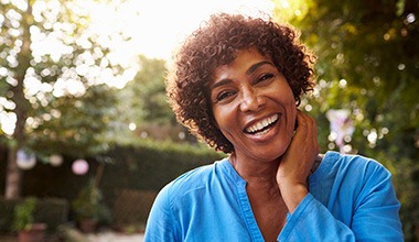 Middle-aged woman showing off her smile after seeing a BlueCross BlueShield dentist in Worthington 
