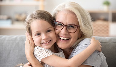 Older woman hugging young girl