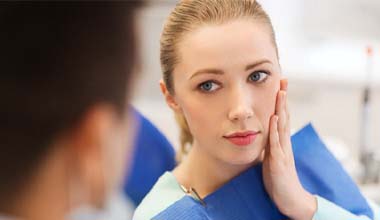 woman with toothache visiting her Worthington emergency dentist