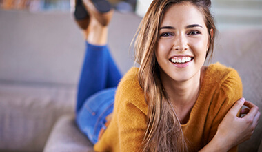 smiling woman in yellow sweater