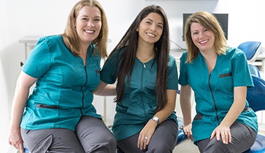A trio of women working at a dental clinic
