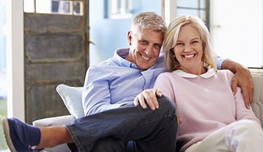 An older couple with dental implants in Worthington smiling.