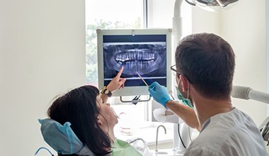 dentist showing a patient their dental X-rays 