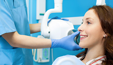 Worthington preventive dentistry hygienist giving smiling woman dental x-ray