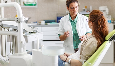 a dentist explaining the cost of root canal therapy