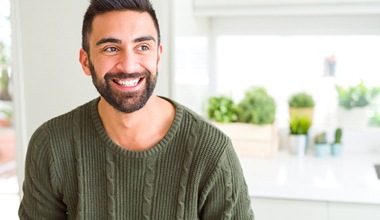 happy person standing in their kitchen