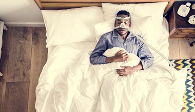 person sleeping with a CPAP machine