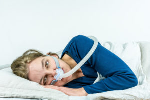 Woman with CPAP mask awake
