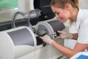 woman using cerec milling machine