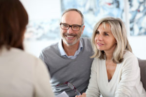 older couple discussing with a professional