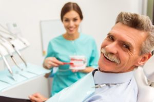 Man learning about dental implants and dentures.