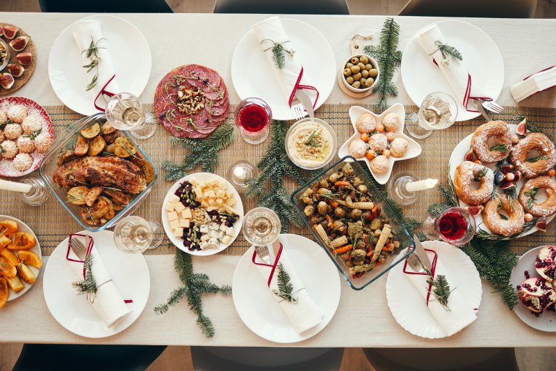 A dining room table covered in holiday food