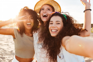 Group of friends taking a selfie on the beach